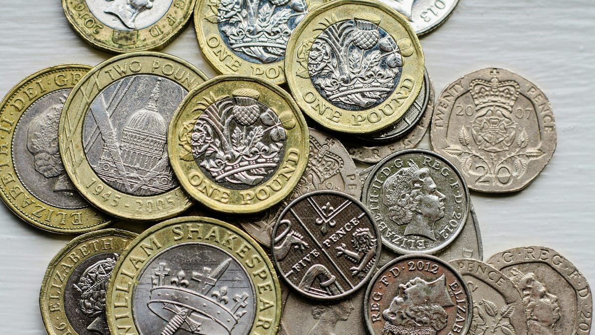 A pile of British pound sterling coins on a table